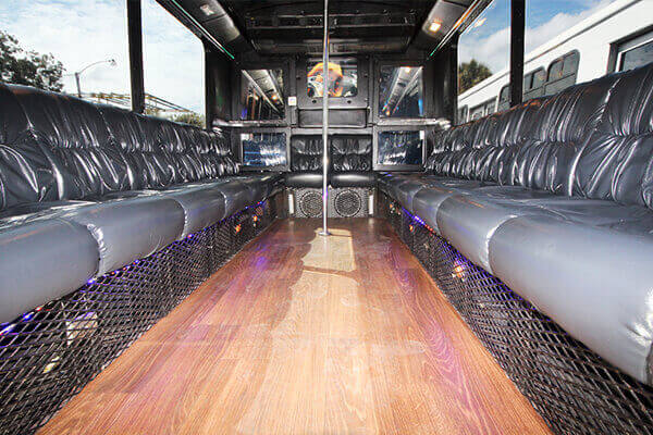 Wood floors and dance poles on party bus